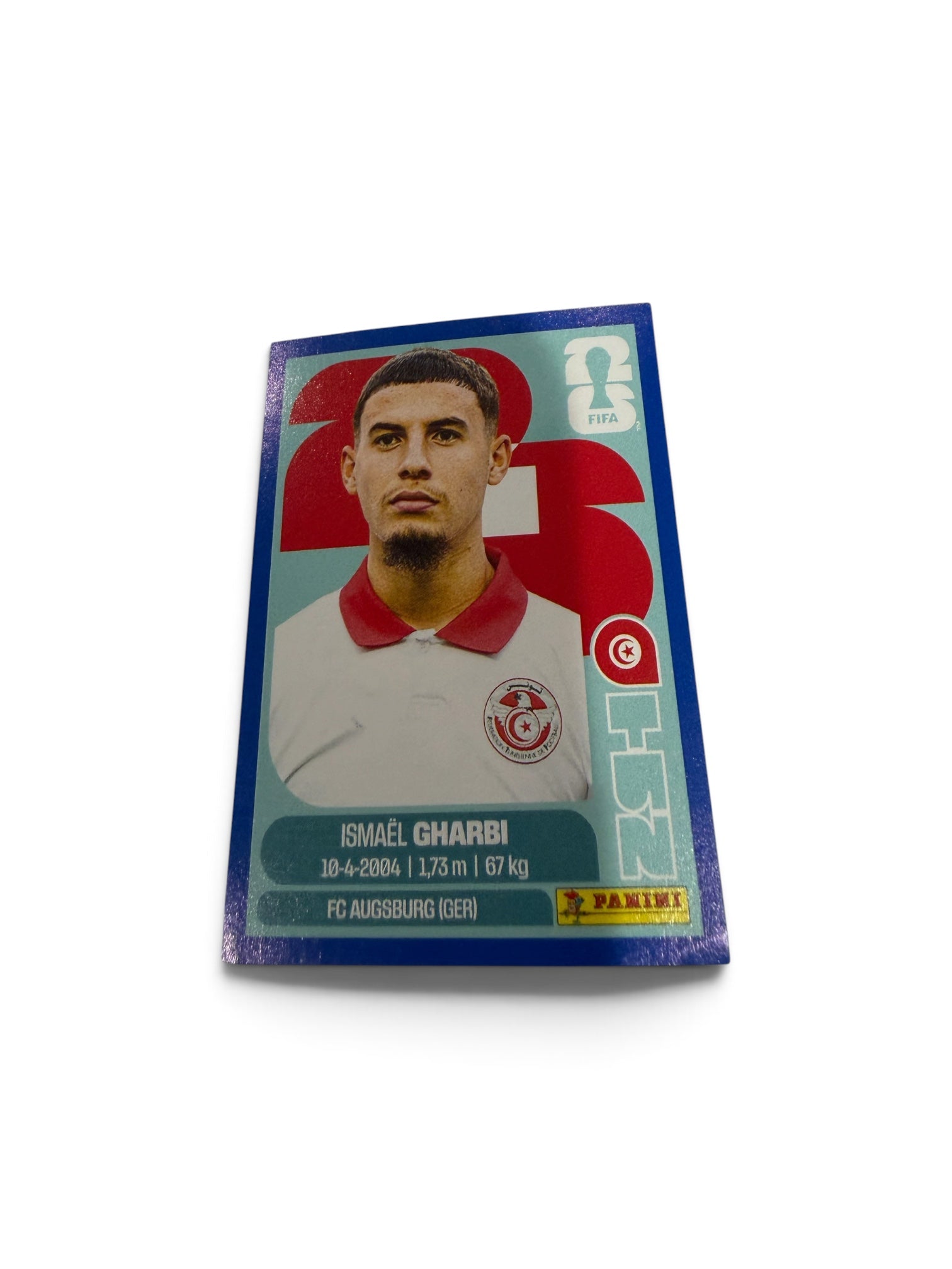 2026 Panini FIFA World Cup Blue Border Parallel TUN18 Ismaël Gharbi Tunisia Official Sticker